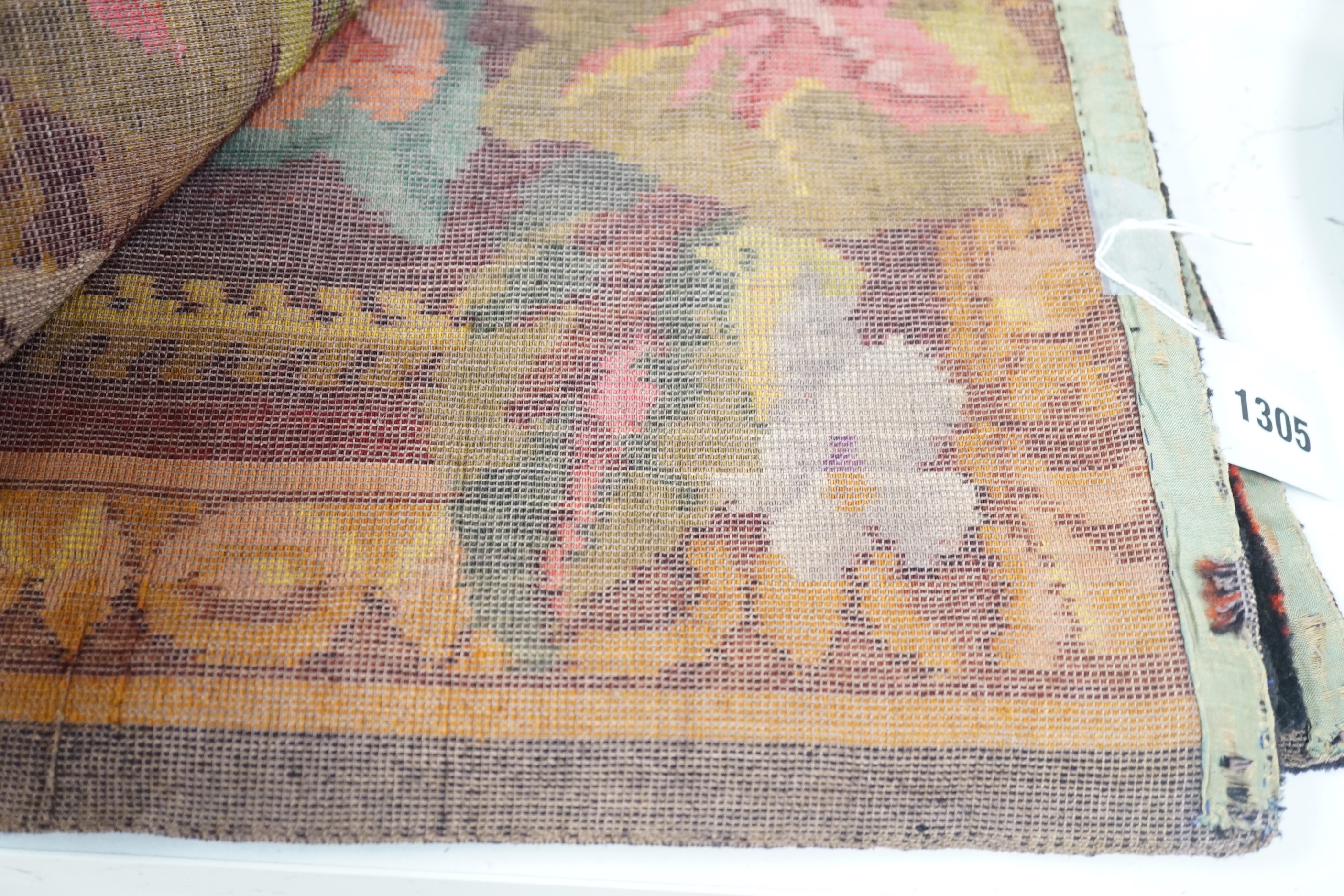 An early 20th century woven multi coloured plush floral piano or table cover